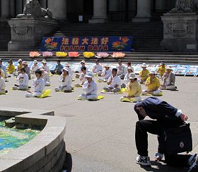 對著法輪功學員單腿下跪的溫哥華市民安吉