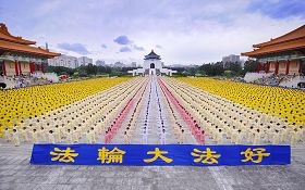 '亞洲法會召開前夕，來自台灣各地、日本、韓國、新加坡等十個國家以外，還有澳洲、新西蘭及美國等七千多人在台北自由廣場集體煉功，壯觀宏大的場面吸引許多遊客。閃光燈不停的拍拍響著。'