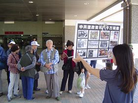 遊客觀看展板，或閱讀真相資料