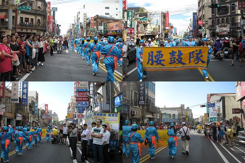 人們圍在道路兩旁觀看腰鼓隊的表演，並拍照。