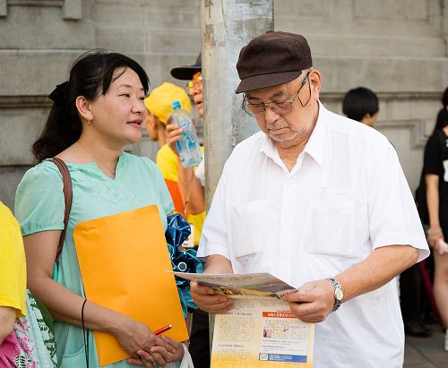 圖10：學員（左）給民眾派發資料、講述法輪功的真相。