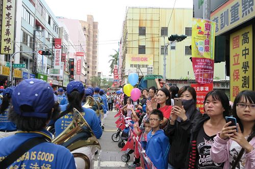 '圖3～4：街道兩側聚集眾多民眾，紛紛拍照，拍手叫好。'