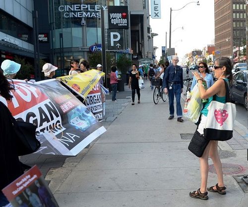 圖10：在繁華的Yonge & Eglinton路口，西人女士Lisa路過路口時停下來用手機拍照，表示要放到Facebook上。