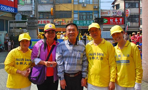 圖1：梅山國小校長邱文嵐（左二）和梅山鄉鄉長劉宏文（中）與法輪功學員合影，歡迎法輪功學員參加梅山國小創校一百一十週年校慶踩街。