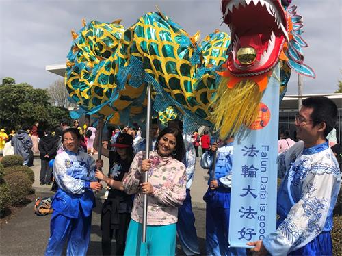 '圖1：皮尼克女士（中）喜歡法輪功學員的舞龍表演。'