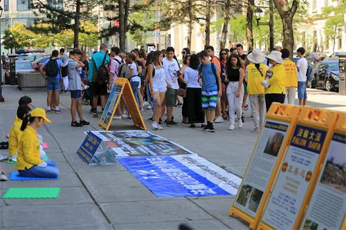 '圖1～2：二零一九年七月十三日，法輪功學員在加拿大首都渥太華市中心最繁華的拜沃德市場（ByWard Market）西南角的喬治街上傳播真相。'