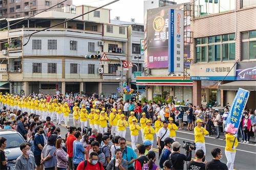 '圖6～7：祥和優美的法輪功煉功隊伍，經過主席台時，很多貴賓揮手致意，有不少民眾用手機、相機拍照。也有民眾詢問到哪裏可以學煉。'